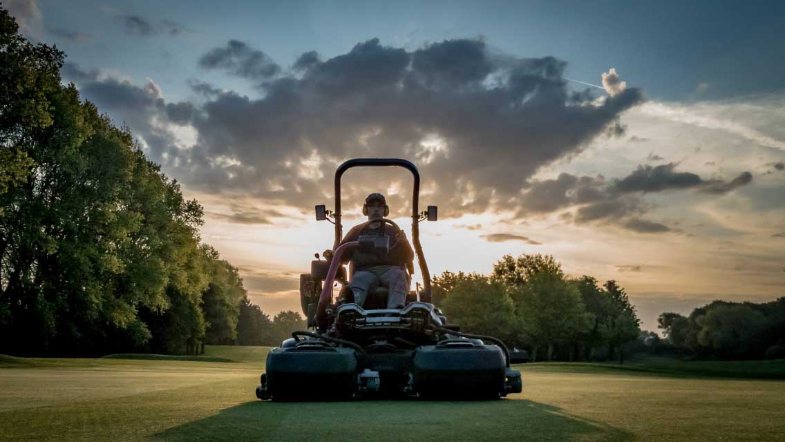 Royal Norwich Greenkeeper cutting grass